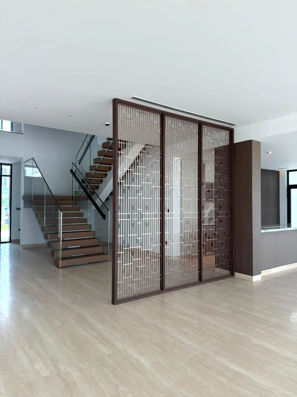 Metal screen enclosing the stair, seen across the living area