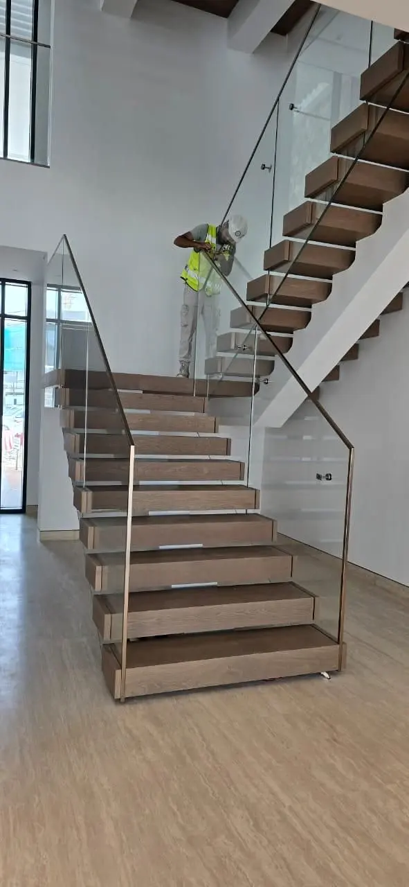 Timber treads and glass balustrade on the upper flight