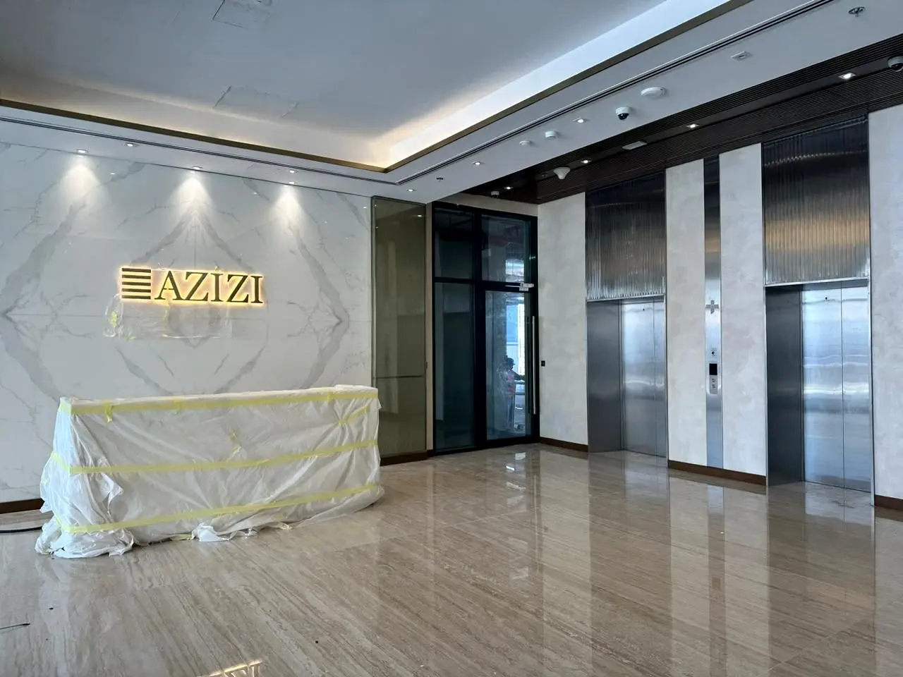 Reception and lift lobby with cove-lit ceiling