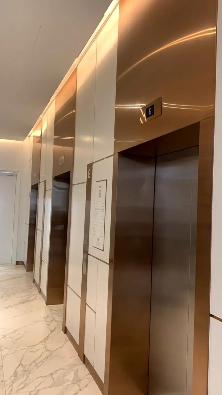 Lift lobby corridor with timber-framed lift portals
