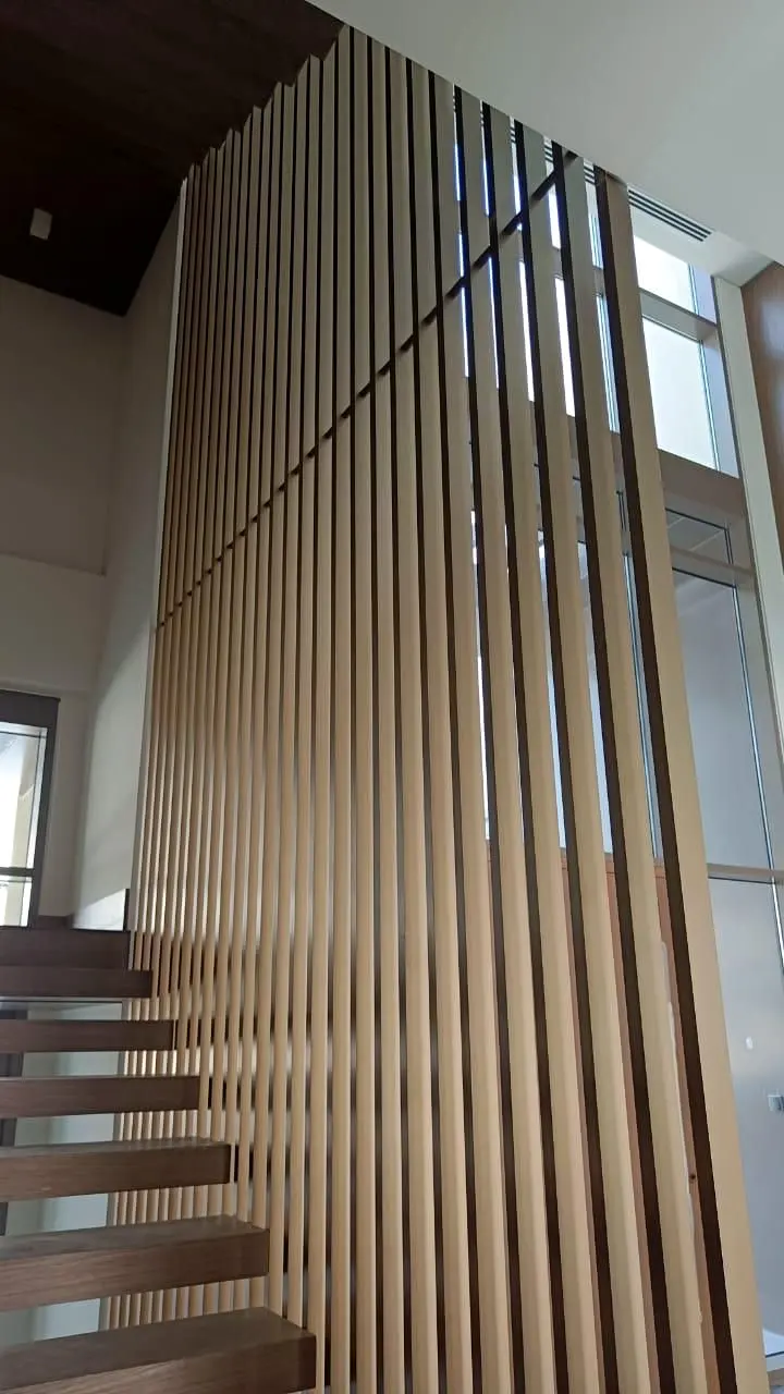 Full-height timber fin screen enclosing a villa staircase