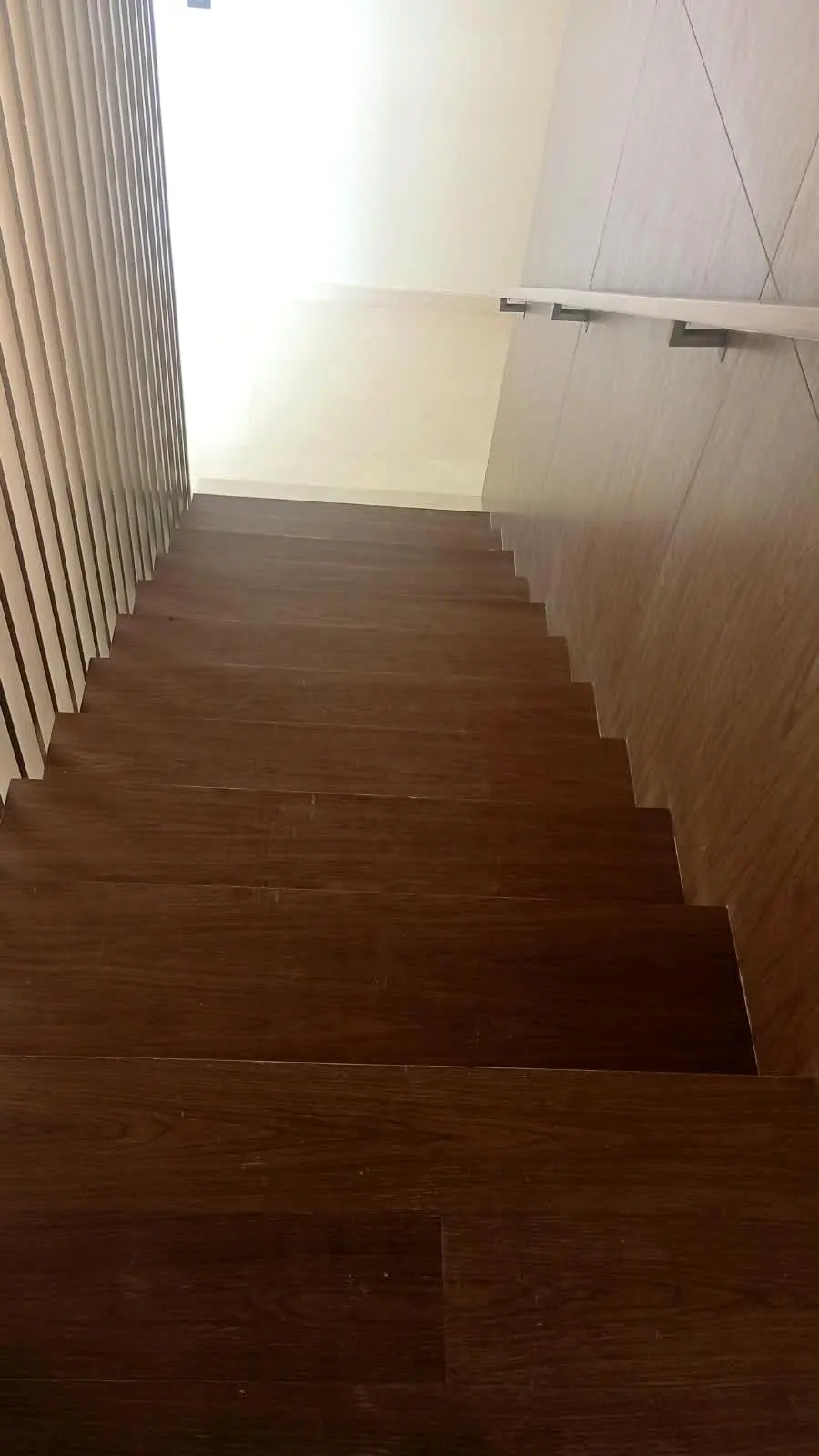 Timber-clad stair flight with a recessed handrail