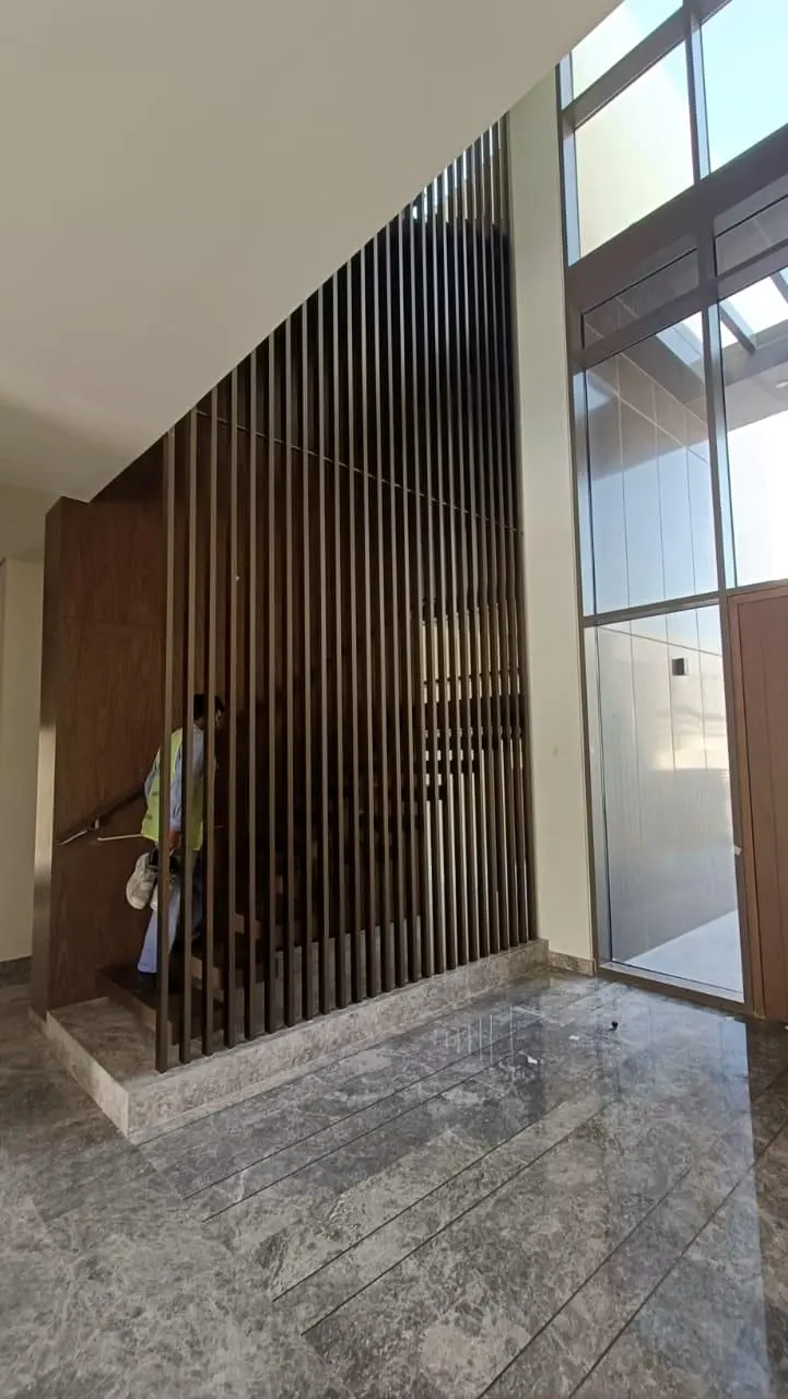 Timber fin screen beside full-height glazing