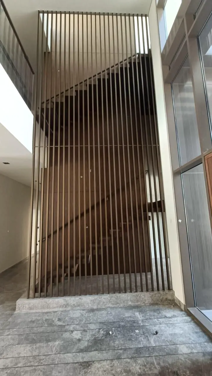 Timber fin screen viewed from the entrance hall