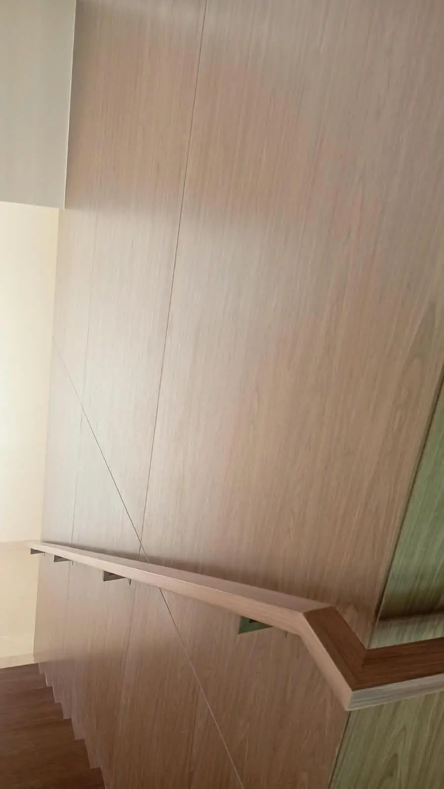 Timber wall cladding with handrail on the stair