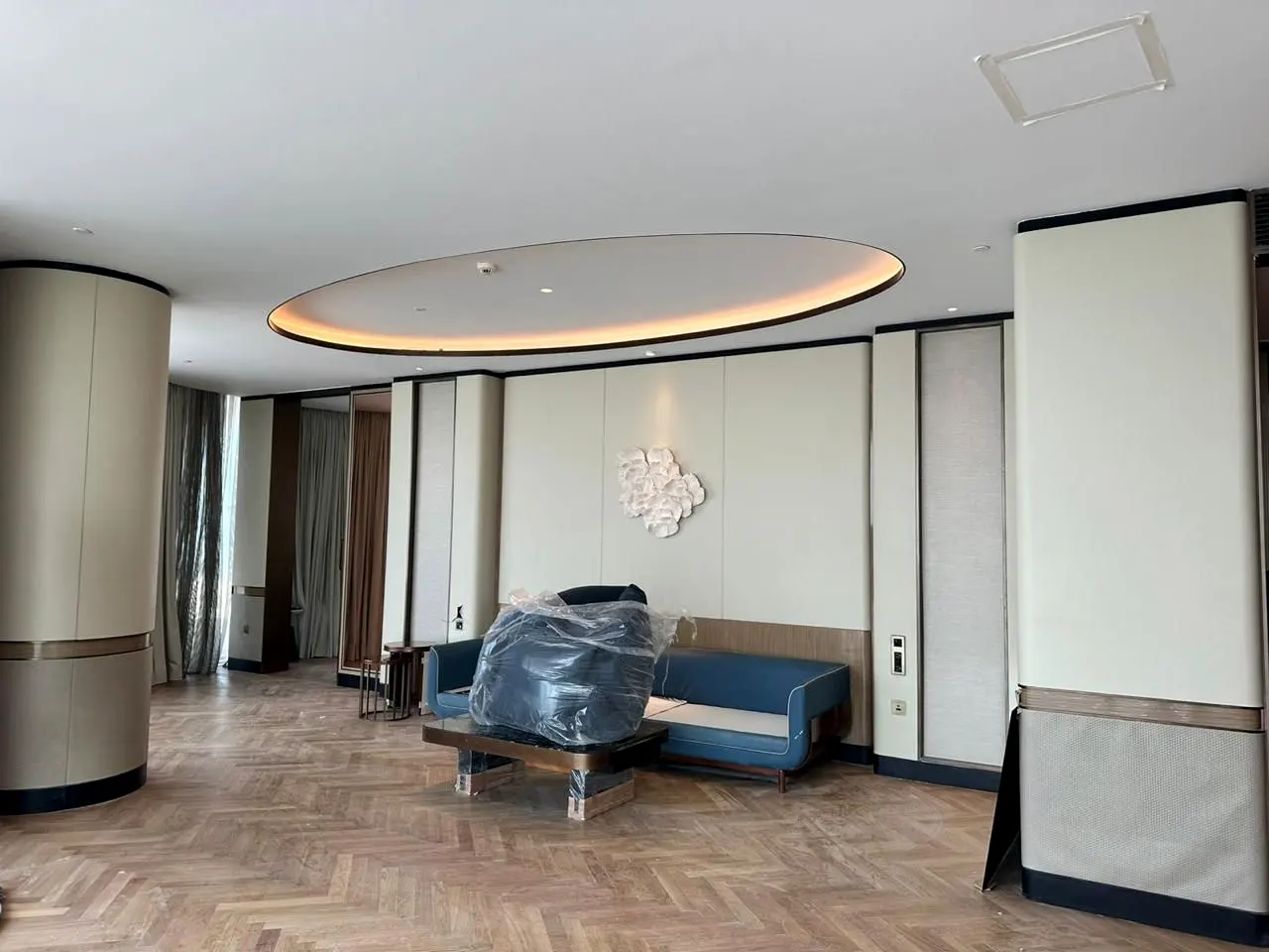 Suite living area with oval false ceiling and wall panelling