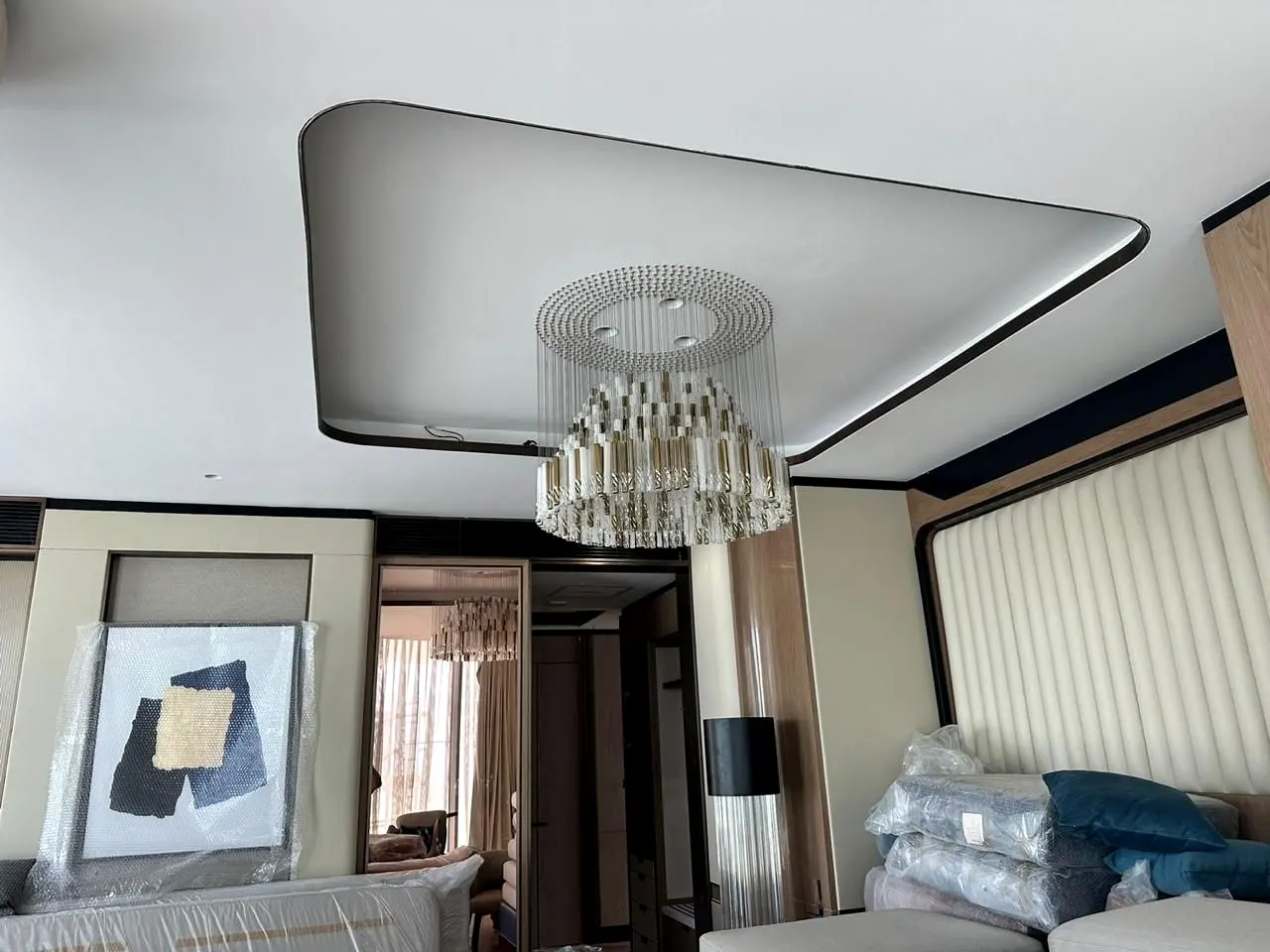 Bedroom with stepped false ceiling and chandelier