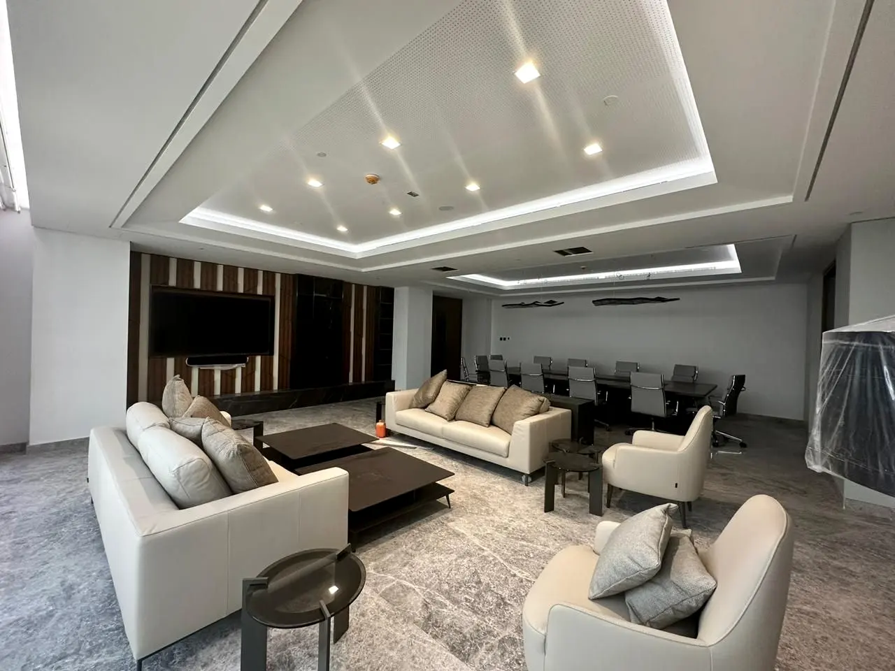Majlis with coffered lit ceiling, timber joinery wall and lounge seating