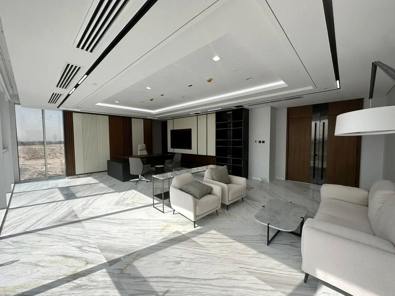 Executive lounge with lit ceiling detail and stone floor