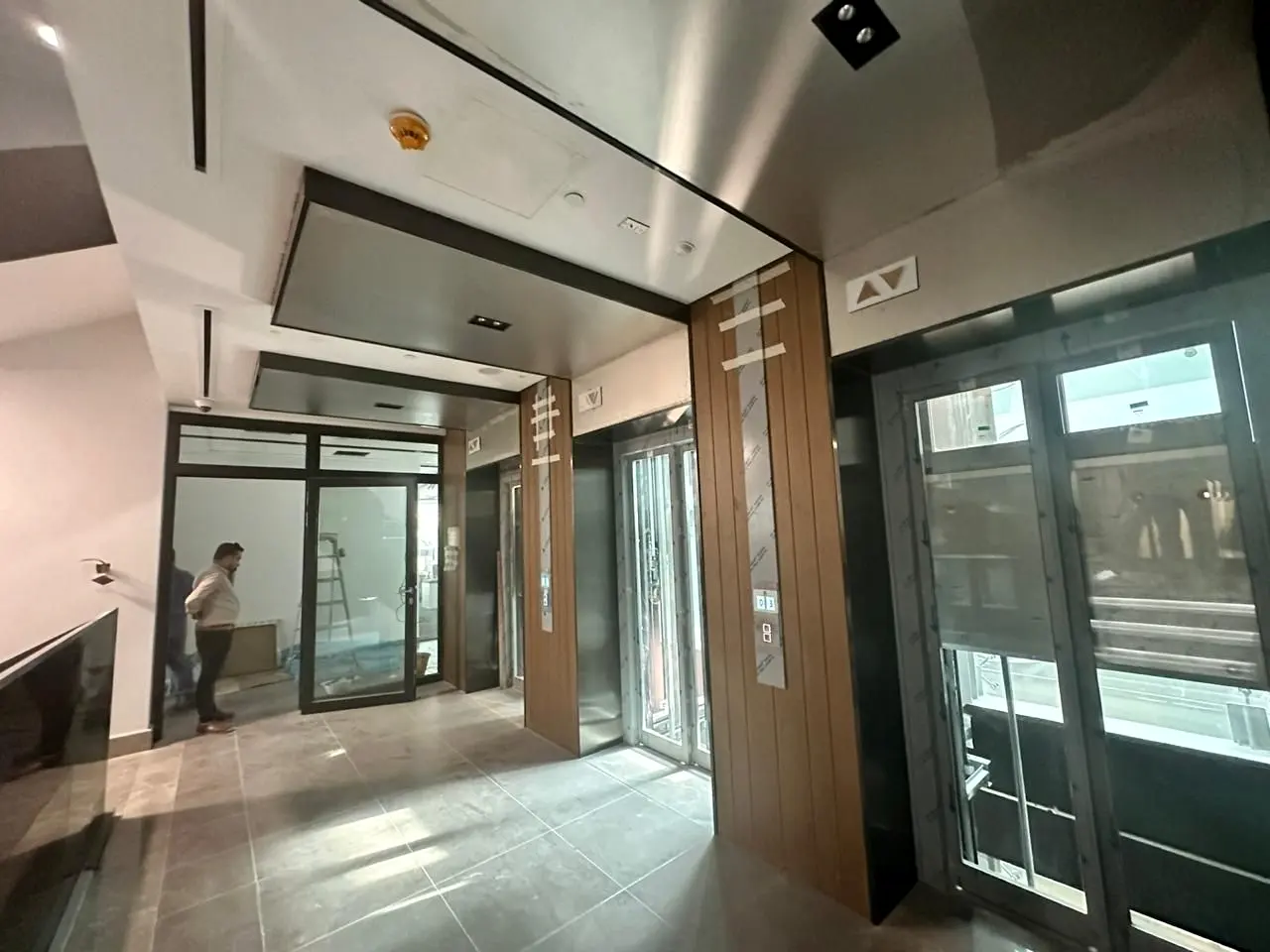 Lift lobby with timber-clad portal and glazed doors