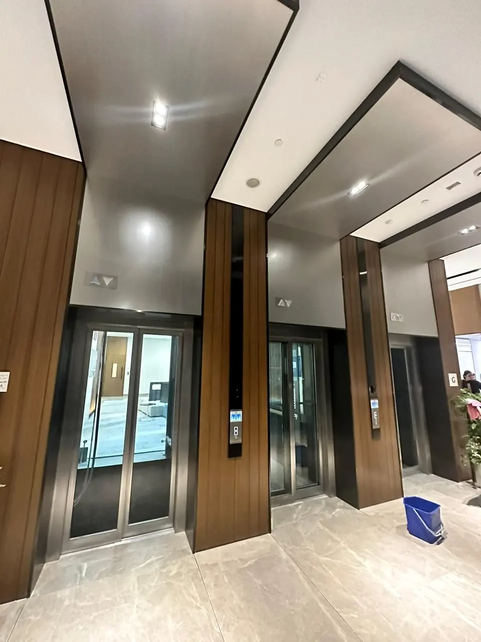 Timber-clad portal framing a glazed lift lobby