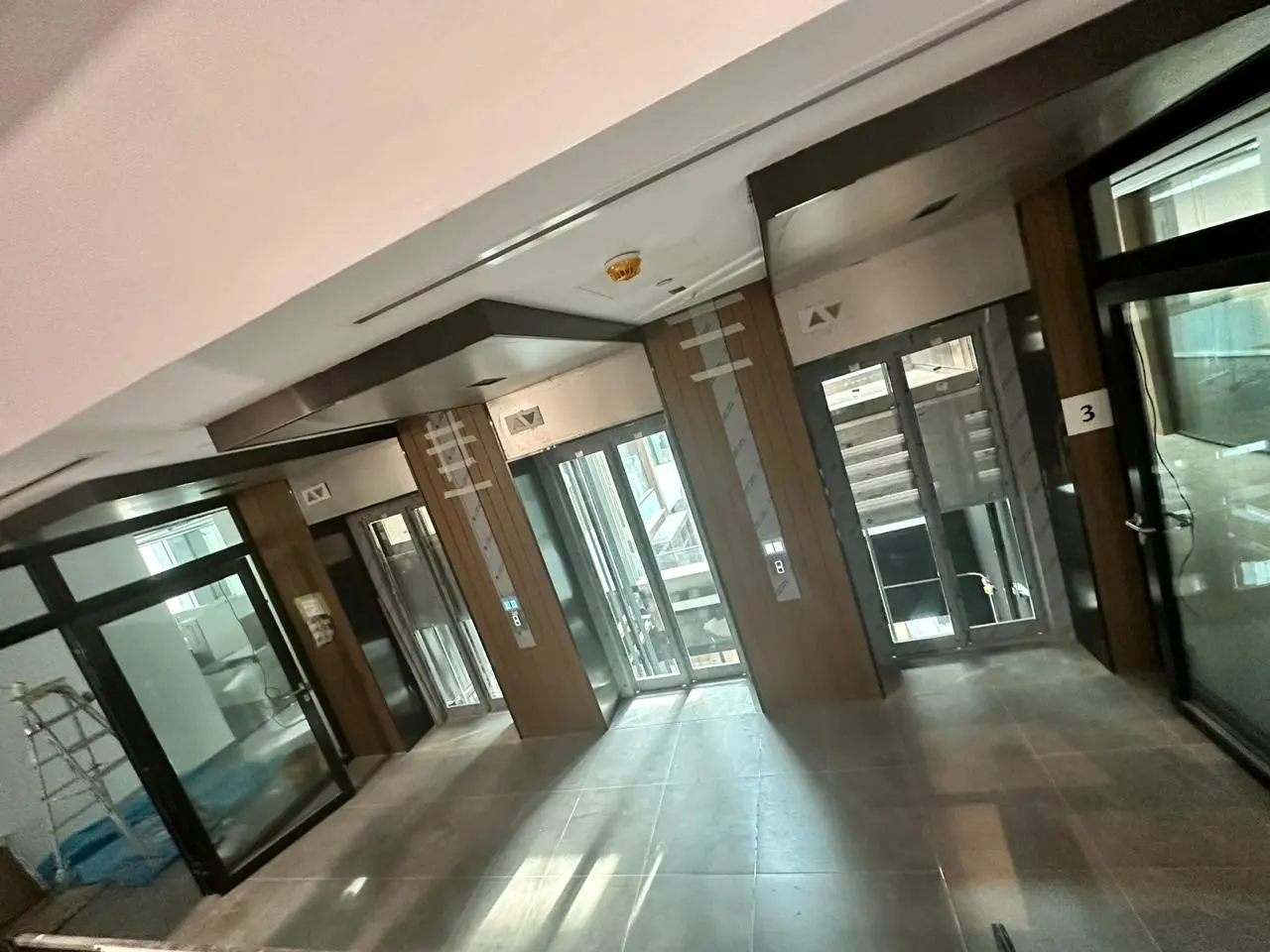 Glazed partition and timber portal in the lift lobby