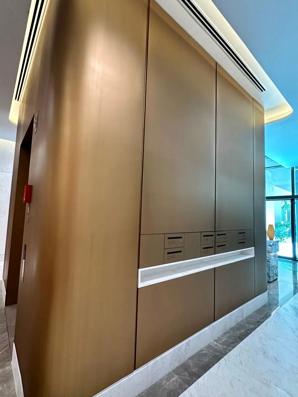 Bronze-finish wall cladding along the lobby